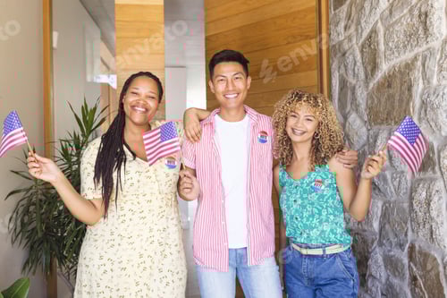 Preview: Diverse friends hold American flags and are wearing vote badges