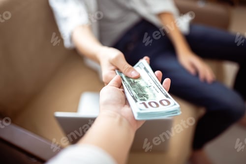 Preview: The mother gives her son a bundle of dollars. The client pays for the work by handing over money