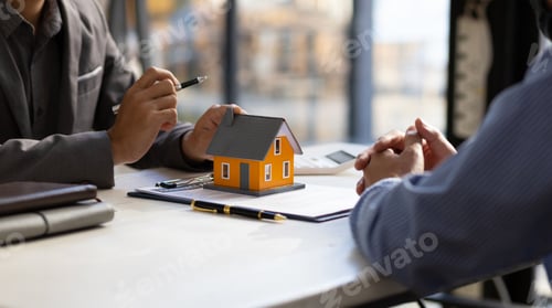 Preview: Real estate agent discuss terms of the home purchase agreement and customer sign the documents.