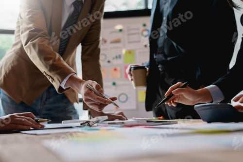Preview: Group of businesspeople meeting and presenting, discussing and analyzing data, pointing to charts