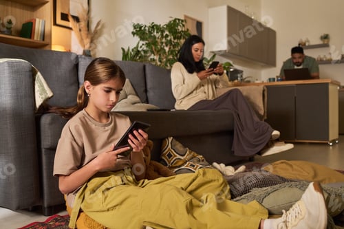 Preview: Family Using Gadgets in Cozy Living Space at Home