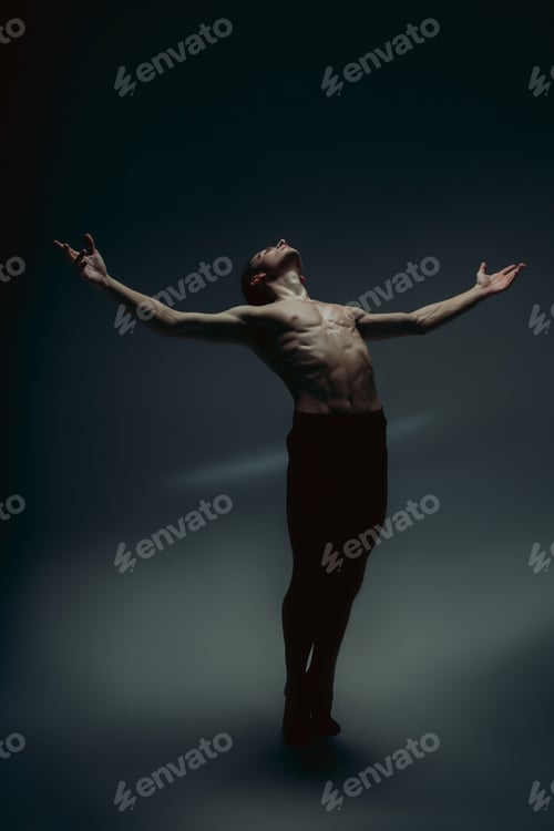 Preview: Young and graceful ballet dancer in minimal black style isolated on black studio background