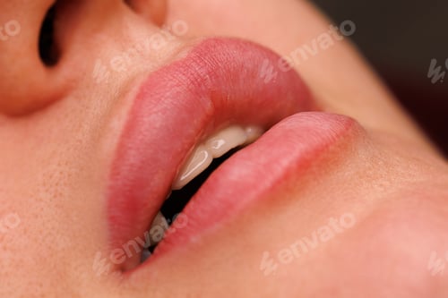 Preview: A close up of a womans lips one month after tattooing.