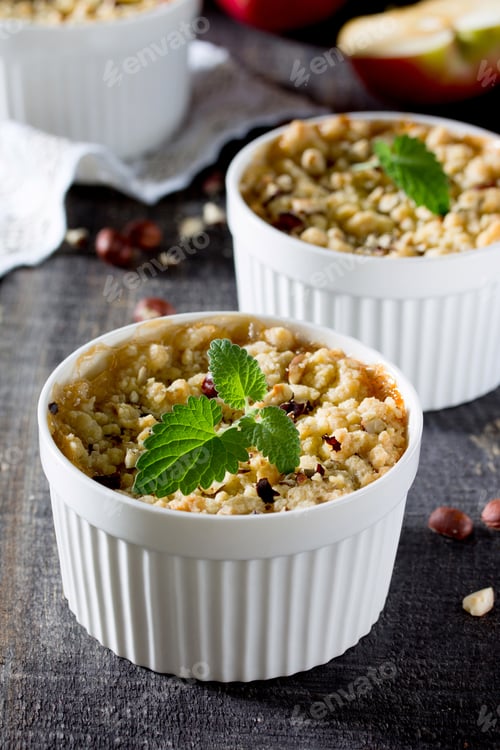 Preview: Dessert crumble with apple and nuts on a dark wooden table