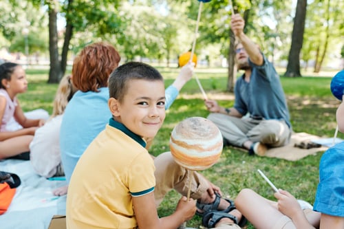 Preview: Smiling boy holding planet model