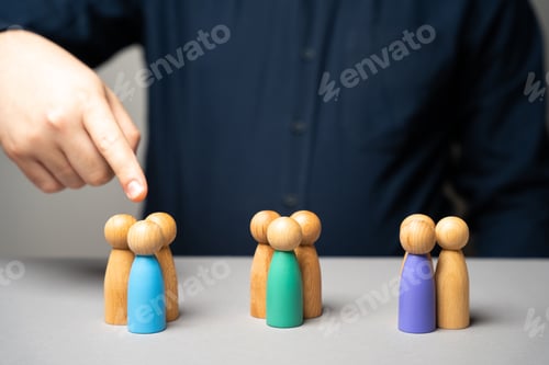 Preview: Businessman points his finger at wooden figurines of people