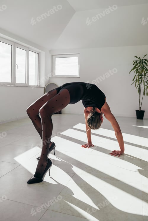 Preview: Young elastic woman in a wheel yoga pose
