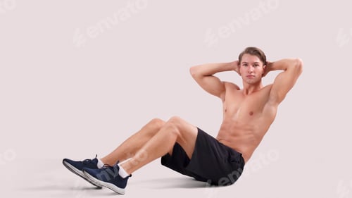 Preview: Athletic young man with sexy body doing abs exercises over light studio background, panorama