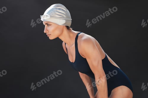 Preview: Professional female swimmer on black background