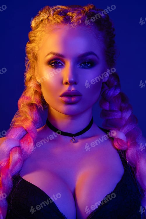 Preview: Portrait of seductive young European woman surrounded by evening neon lights medium close-up