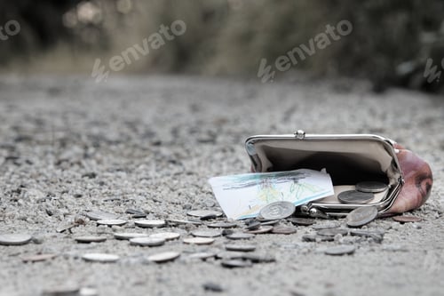 Preview: Closeup shot of a lost wallet with money on the ground on street