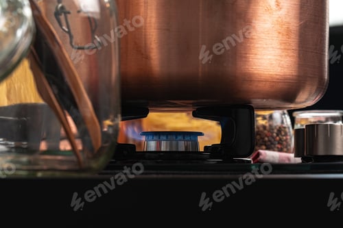 Preview: Metal pot on a gas stove burner close up