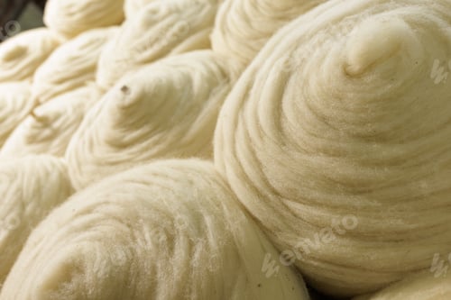 Preview: Merino wool fiber rolls texture background for textile production industry