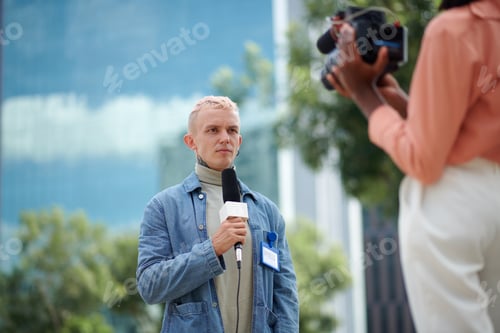 Preview: Serious Journalist Speaking in Microphone