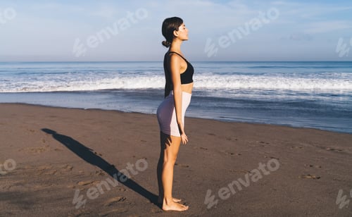 Preview: Caucasian woman in sportive clothes meditate during sunshine near Caribbean sea,