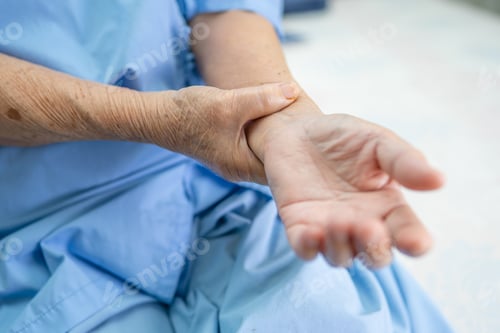 Preview: Asian senior or elderly old lady woman patient feel pain her hand on bed