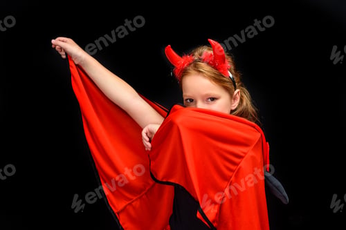 Preview: kid in halloween costume of devil, isolated on black