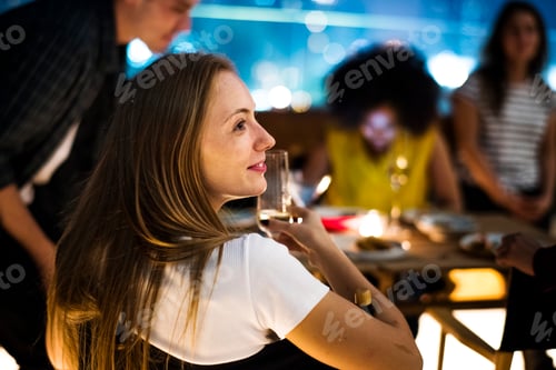 Preview: Young adults dinner night with friends at a rooftop restaurant