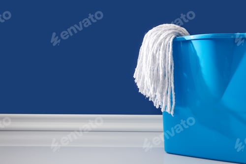 Preview: rag and bucket for spring cleaning on blue
