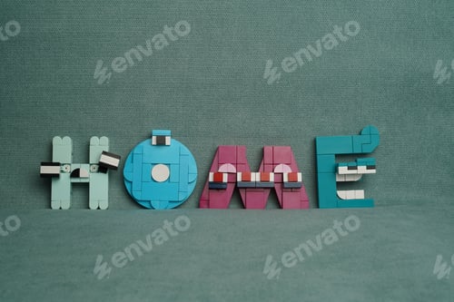 Preview: Miniature figure of the word home against a greenish fabric background