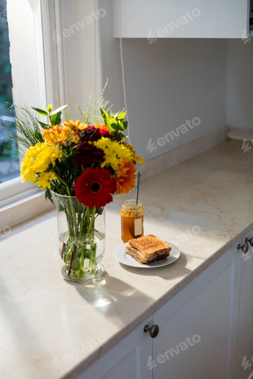 Preview: Flower vase and breakfast on worktop in kitchen