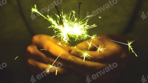 Preview: Human hands celebrating new years eve sparklers sparkling fireworks