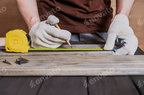 Preview: Banner of Carpenter Measuring a Wooden Plank by ruler in wooden workshop, carpenter