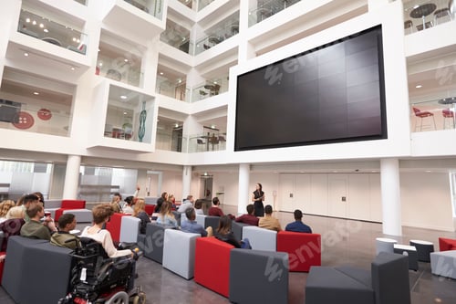 Preview: Students at a lecture in the atrium of a modern university