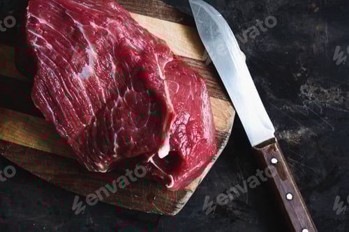 Preview: Raw beef and cutting knife on wood board