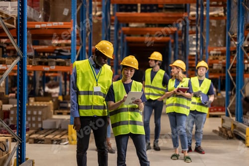 Preview: Warehouse workers using digital tablet and inventory management software