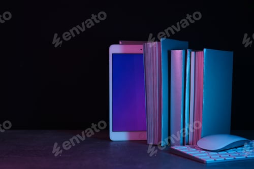 Preview: Books, tablet, keyboard and mouse on black background, space for text