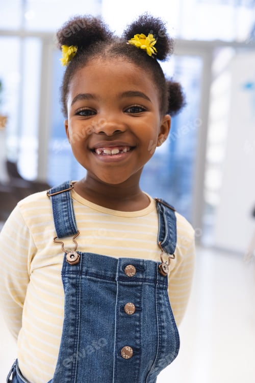 Preview: Portrait of happy african american girl patient in waiting room at hospital