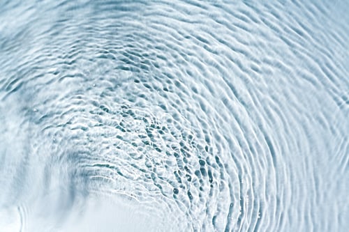 Preview: Clear turquoise pool water glistens under sunlight with gentle ripples