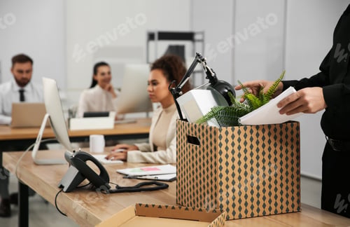 Preview: Dismissed man packing stuff into box at office, closeup. Space for text