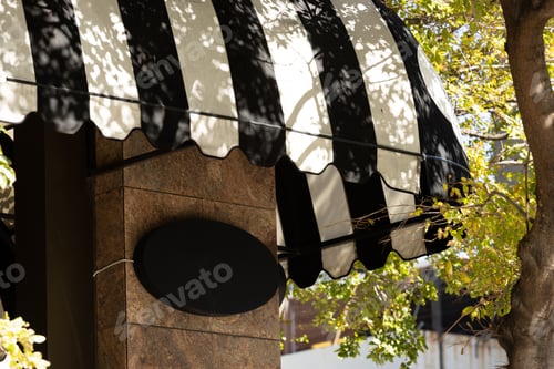 Preview: Blank oval sign fixed to building wall with copy space