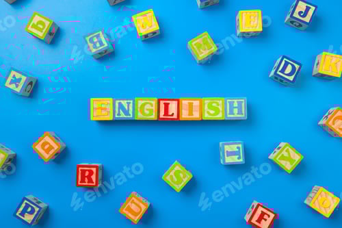Preview: English. Wooden colorful alphabet blocks on blue background, flat lay, top view