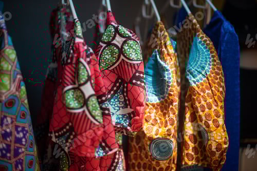 Preview: Close up shot of colorful african dresses hanging on rack