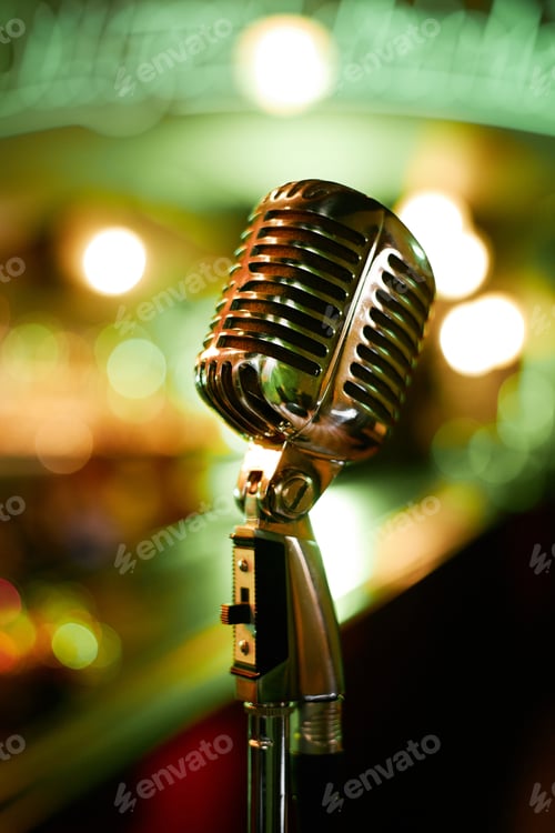 Preview: Old Fashioned Chrome Mic Standing against Green Neon Lights in Jazz Club