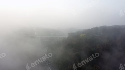 Preview: A city covered in fog. City traffic, aerial view