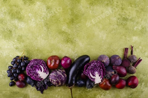 Preview: Assortment of purple vegetables on green background