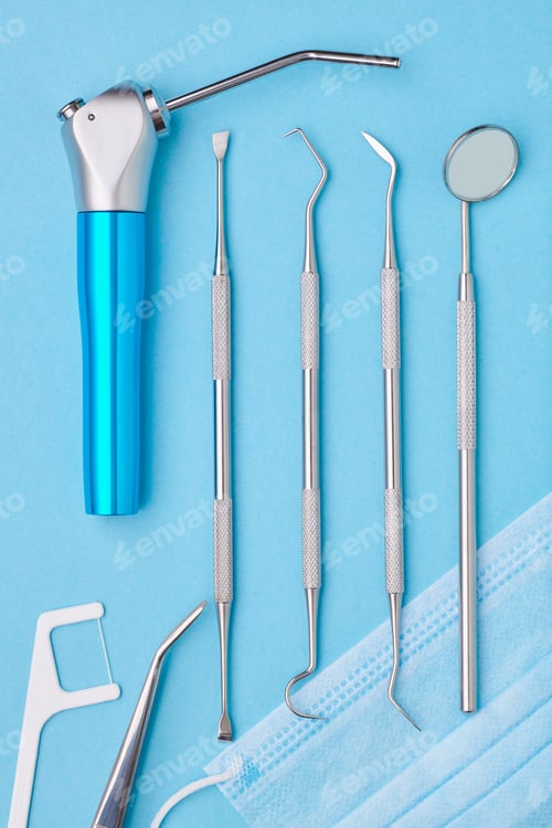 Preview: Dentist tools over blue background top view