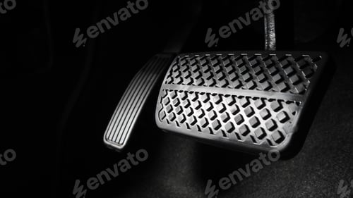 Preview: Man foot and accelerator and brake pedal inside the car