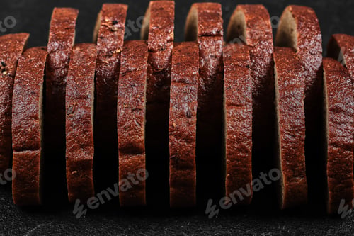 Preview: Sliced black bread on dark background