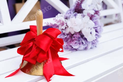 Preview: Close-up of a bell with a red ribbon. The celebration of the last bell at school.
