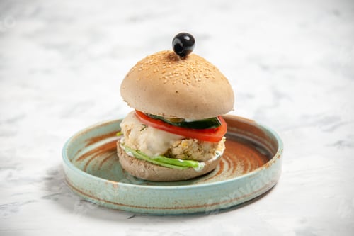 Preview: Close up shot of homemade delicious sandwich with black olive on a plate on stained white background
