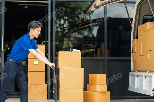 Preview: Asian delivery man, driver with the parcel on the seat outside the warehouse.