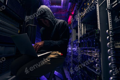 Preview: Experienced cybercriminal gaining unanthorized access to data using his laptop