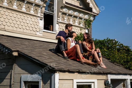 Preview: Happy friends sitting on roof