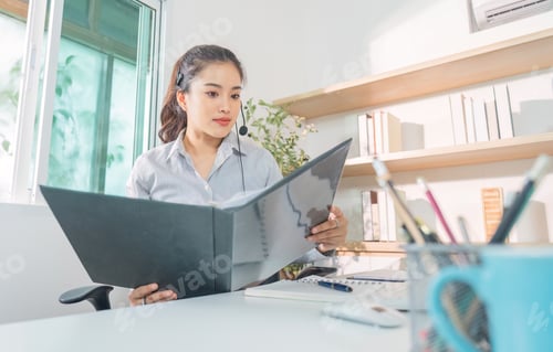 Preview: Remote Work. Professional woman engaged in virtual meeting at home office.