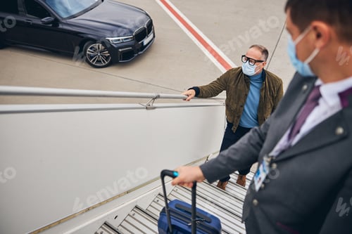 Preview: Business entrepreneur going up the aircraft steps